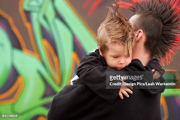 father and son with mohawks - goth boy stock-fotos und bilder