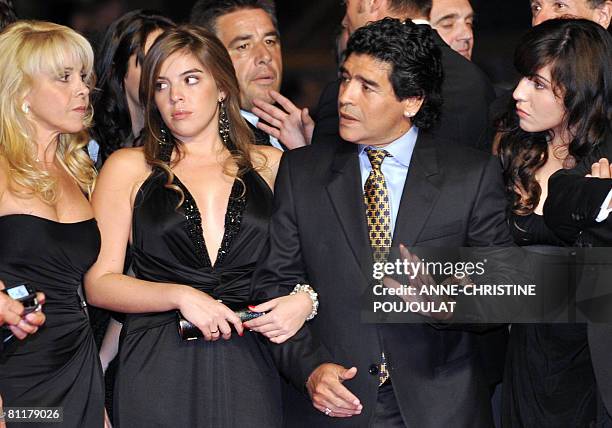 Former Argentinian football player Diego Maradona gestures as he arrive with his wife Claudia and daughters Dalma and Giannina to attend the...