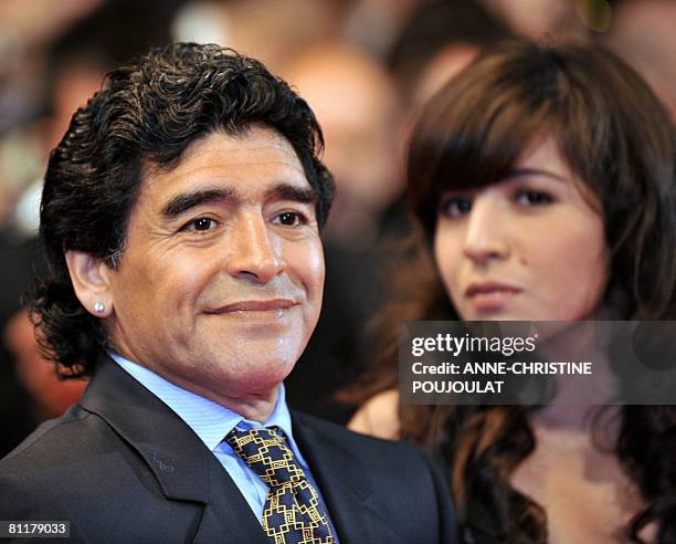 Former Argentinian football player Diego Maradona poses as he arrives with his daughter Giannina to attend the screening of Serbian director Emir...