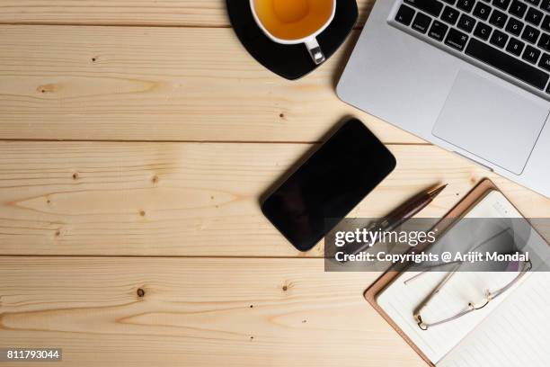 smart phone on wooden office table top view shot with laptop keyboard - aerial view desk stock pictures, royalty-free photos & images