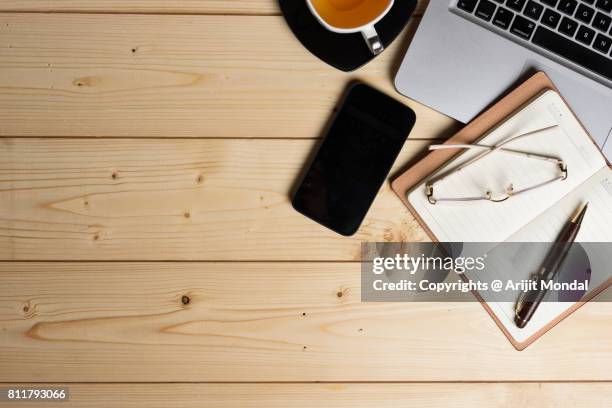 diy table top view with smart phone, green tea cup, computer keyboard, spectacle and copy space - tea cup overhead view photos et images de collection