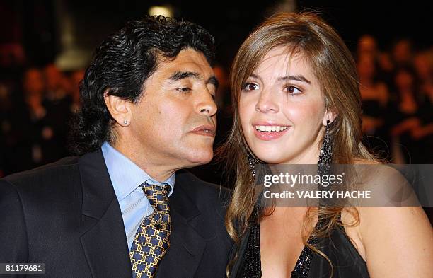 Former Argentinian football player Diego Maradona is about to kiss his daughter Dalma as he arrives with his relatives to attend the screening of...