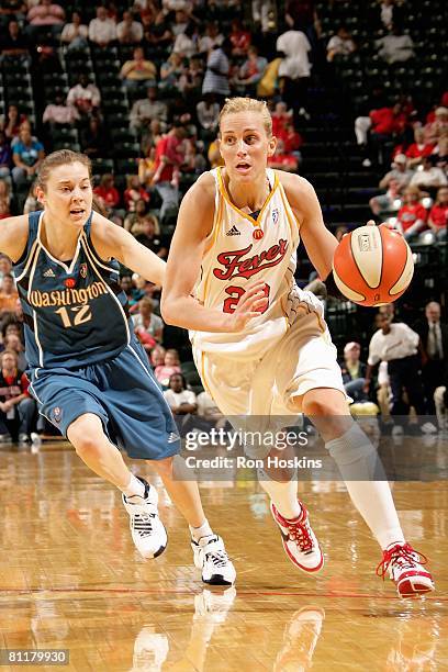 Katie Douglas of the Indiana Fever drives to the basket trailed by Laurie Koehn of the Washington Mystics during the WNBA game on May 17, 2008 at...