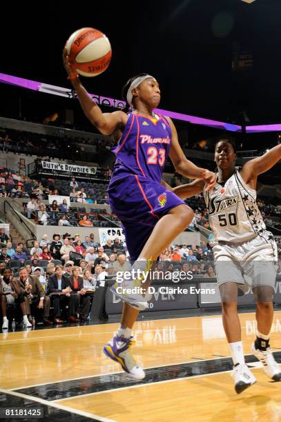 Cappie Poindexter of the Phoenix Mercury passes against Sandora Irvin of the San Antonio Silver Stars on May 20, 2008 at the AT&T Center in San...