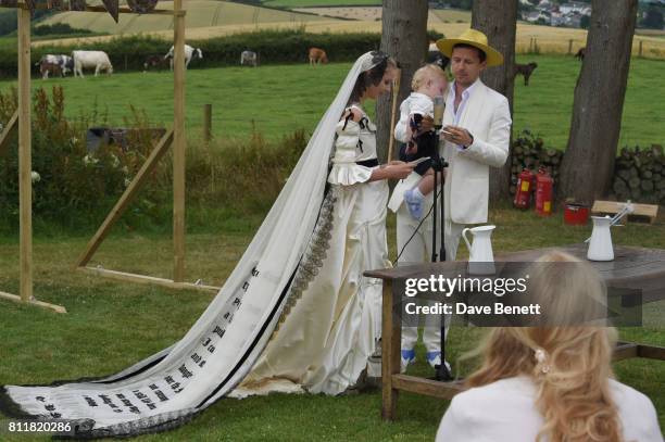 Greta Bellamacina and Robert Montgomery with son Lorca attend their wedding on July 8, 2017 in Exeter, England.