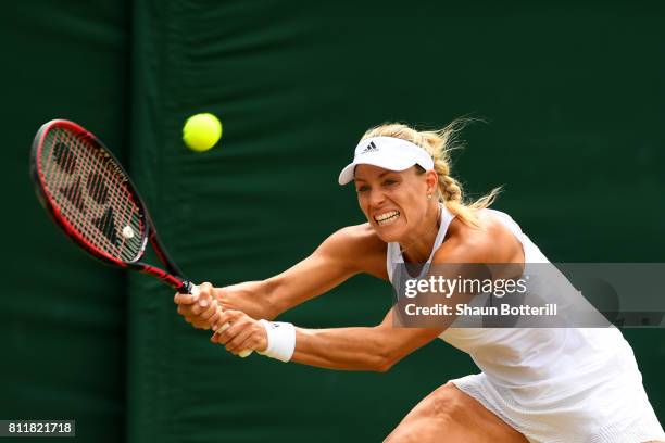 Angelique Kerber of Germany plays a backhand during the Ladies Singles fourth round match against Garbine Muguruza of Spain on day seven of the...