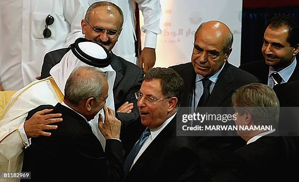 Lebanese Prime Minister Fuad Siniora shares a laugh with Parliament Speaker Nabih Berri as Qatari Emir Sheikh Hamad bin Khalifa al-Thani and other...