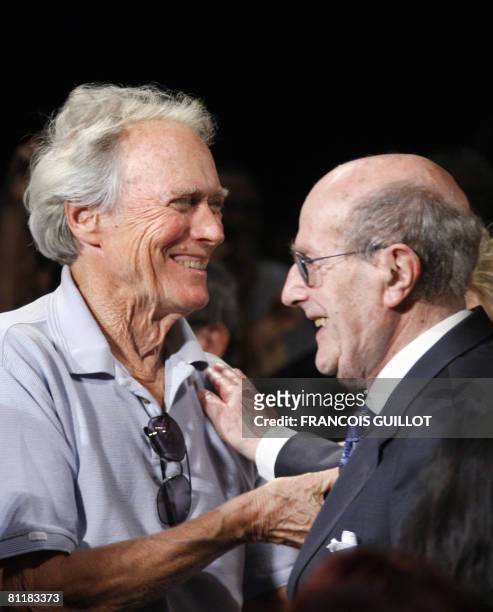 Actor and director Clint Eastwood greets Portuguese director Manoel de Oliveira arriving to attend a ceremony in his honour at the 61st Cannes...