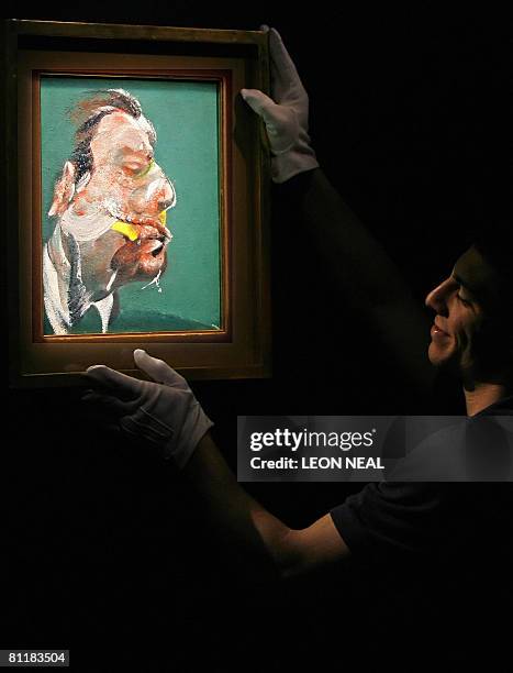 Member of Sotheby's auction house adjusts a painting entitled "Study for Head of George Dyer" by Anglo-Irish artist Francis Bacon in central London,...