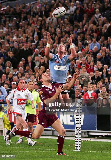 Anthony Quinn of the Blues jumps high over Brent Tate of the Maroons to score his second try during match one of the ARL State of Origin series...