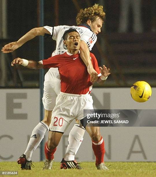 German league and Cup champions Bayern Munich player Andreas Ottl and Bambang Pamungkas of Indonesia vie for the ball during a friendly match between...