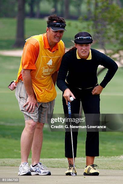 Vicky Hurst and her caddie evaluate the green during the first round of the SemGroup Championship presented by John Q. Hammons on May 1, 2008 at...