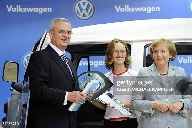 German Chancellor Angela Merkel and Volkswagen CEO Martin Winterkorn present a new VW bus to Daniela Mattern from Germany for the Social project...