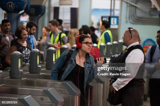 Passenger pushes through the turnstile at Hoboken Terminal on July 10, 2017 in Hoboken, New Jersey. Passengers faced longer-than-usual commutes...