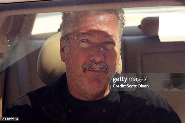 Former Bolllingbrook, Illinois police officer Drew Peterson leaves the Will County Jail in his attorney's car after posting bail for a felony weapons...
