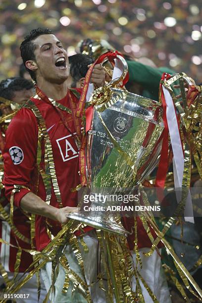 Manchester United's Portugese midfielder Cristiano Ronaldo celebrates with the trophy after beating Chelsea in the final of the UEFA Champions League...