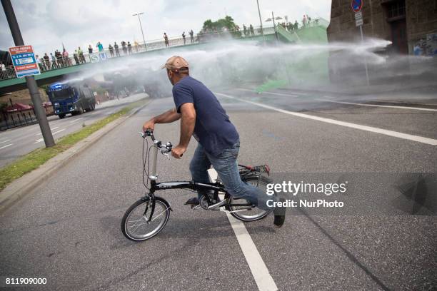 Man rides a bike during G 20 summit in Hamburg on July 7, 2017.