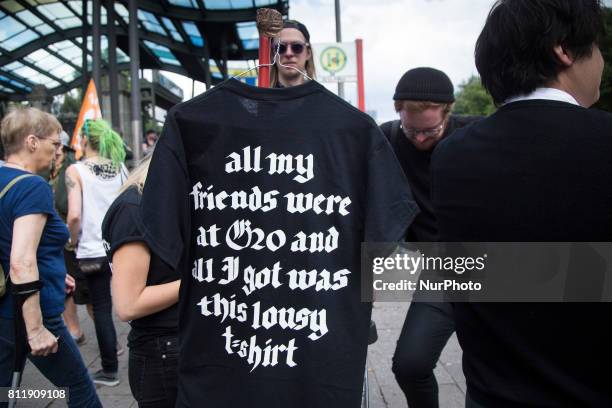 Man sells souvenir t-shirt during G 20 summit in Hamburg on July 8, 2017.