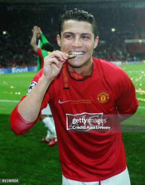 Cristiano Ronaldo of Manchester United bites his winners medal following his team's victory during the UEFA Champions League Final match between...