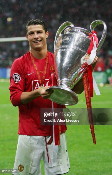Cristiano Ronaldo of Manchester United poses with the trophy following his team's victory during the UEFA Champions League Final match between...