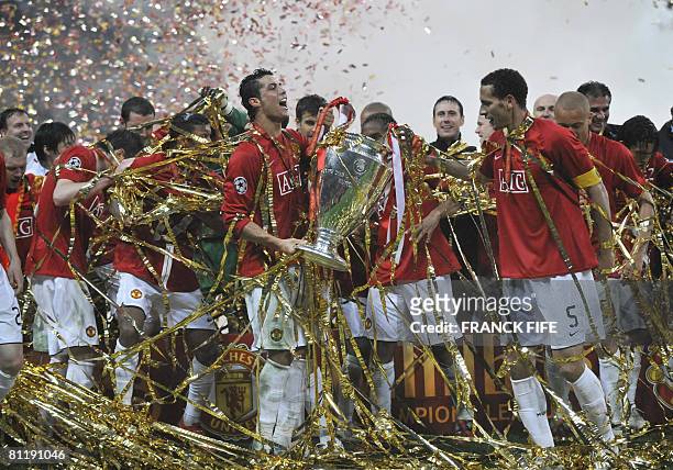 Manchester United's Portugese midfielder Cristiano Ronaldo celebrates with the trophy in front of their supporters after beating Chelsea in the final...