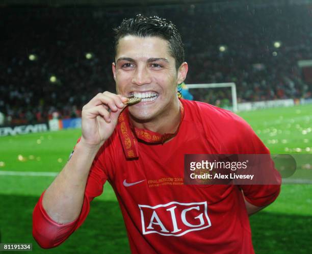 Cristiano Ronaldo of Manchester United bites his winners medal following his team's victory during the UEFA Champions League Final match between...