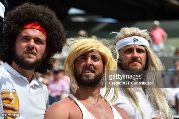 Tennis fans wearing wigs resembling legendary players watch Spain's Rafael Nadal play against Luxembourg's Gilles Muller during their men's singles...