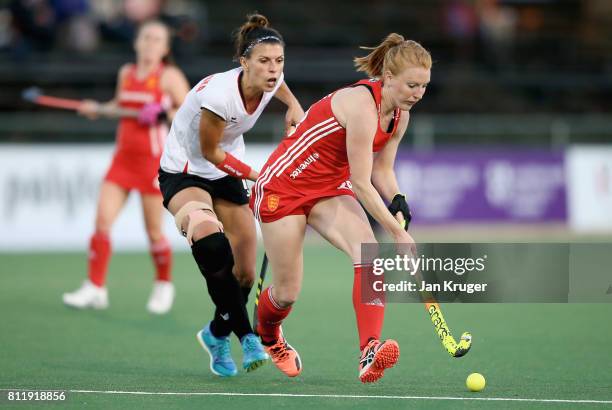 Nicola White of England and Natalia Wisniewska of Poland battle for possession during day 2 of the FIH Hockey World League Semi Finals Pool A match...