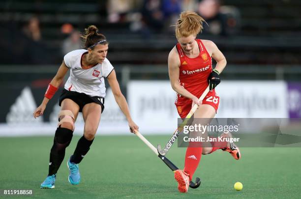 Nicola White of England and Natalia Wisniewska of Poland battle for possession during day 2 of the FIH Hockey World League Semi Finals Pool A match...