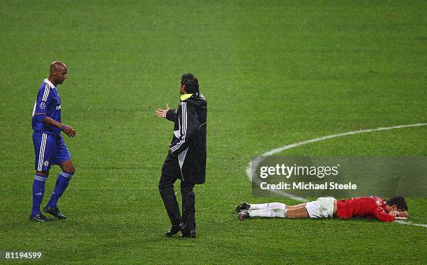 Cristiano Ronaldo of Manchester United lies on the pitch celebrating as a dejected Nicolas Anelka of Chelsea is consoled by teammate Claudio Pizzarro...