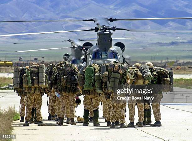 British Royal Marines wait to board a Chinook helicopter April 15, 2002 at Bagram air base, Afghanistan, to be deployed into the mountains of...