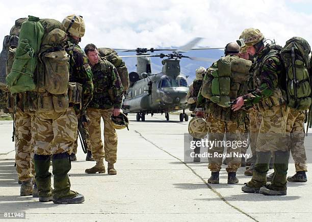 British Royal Marines wait to board a Chinook helicopter April 15, 2002 at Bagram air base, Afghanistan, to be deployed into the mountains of...