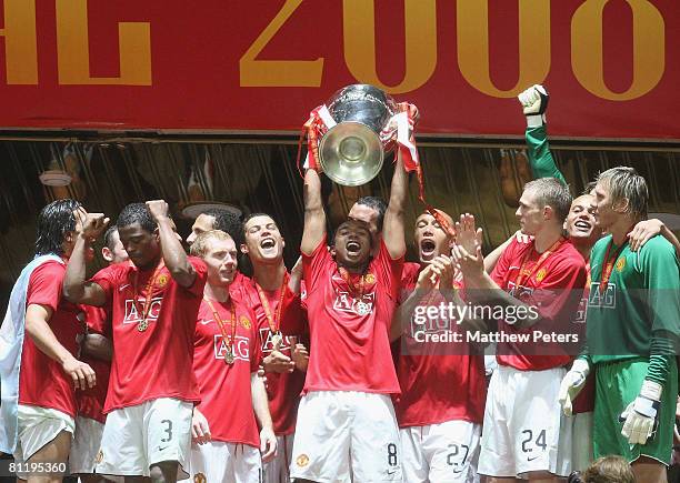 Carlos Tevez, Rio Ferdinand, Wes Brown, Ryan Giggs and Mikael Silvestre of Manchester United celebrates with the trophy after winning the UEFA...