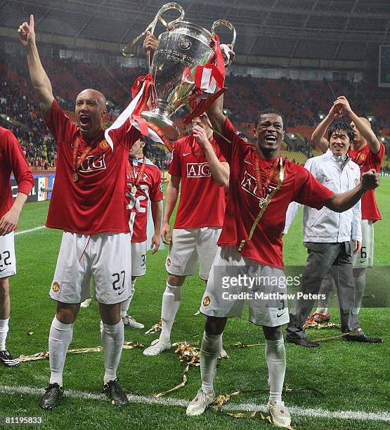 Mikael Silvestre and Patrice Evra of Manchester United celebrates with the trophy after winning the UEFA Champions League Final match between...