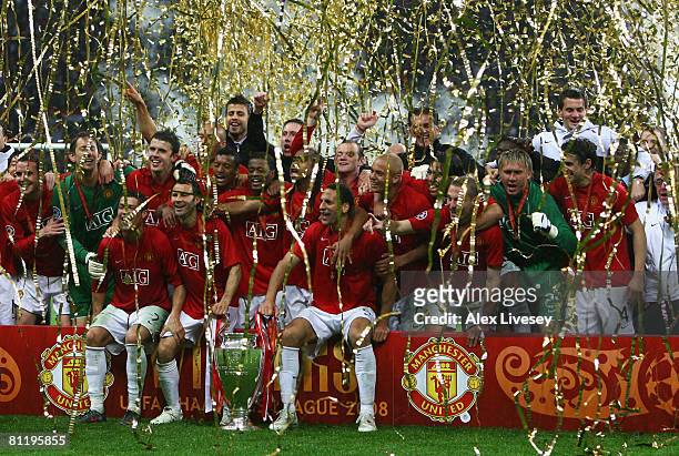 Manchester United players celebrate with the trophy following their team's victory during the UEFA Champions League Final match between Manchester...