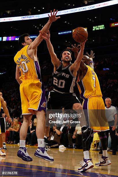 Manu Ginobili of the San Antonio Spurs goes for a shot between Vladimir Radmanovic and Lamar Odom of the Los Angeles Lakers in Game One of the...