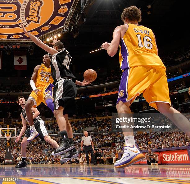 Kobe Bryant of the Los Angeles Lakers makes a pass to teammate Pau Gasol around Tim Duncan of the San Antonio Spurs in Game One of the Western...