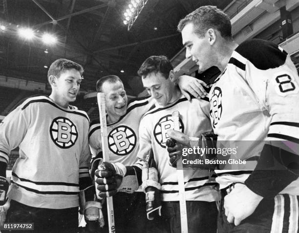 From left, Fred Stanfield, Eddie Shack, Phil Esposito, and Ken Hodge talk on the ice after practice at the Boston Garden, Oct. 2, 1967.