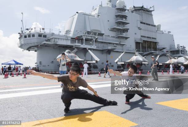 July 9, 2017 : Young people pose for photos on the flight deck of China's first aircraft carrier Liaoning in Hong Kong, south China, July 9, 2017....