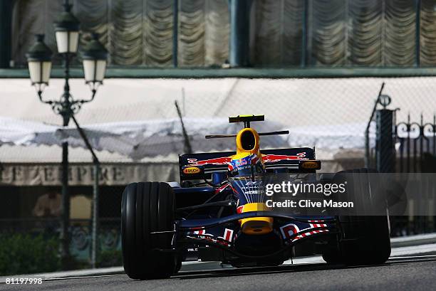 Mark Webber of Australia and Red Bull Racing exits Casino Square while driving during practice for the Monaco Formula One Grand Prix at the Monte...