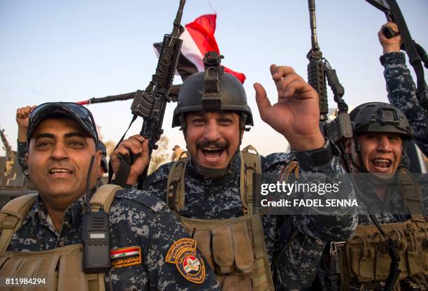 Members of the Iraqi federal police forces celebrate in the Old City of Mosul on July 10, 2017 after the government's announcement of the...