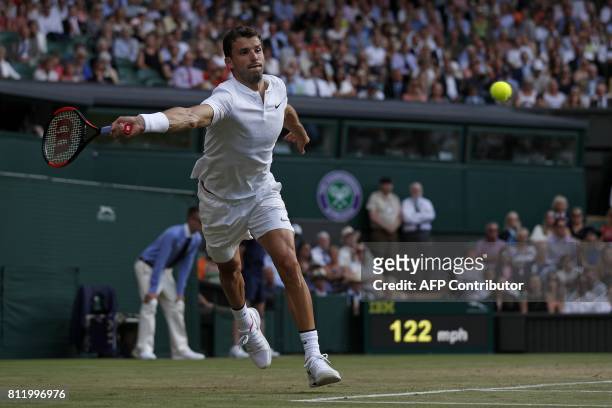 Bulgaria's Grigor Dimitrov returns against Switzerland's Roger Federer during their men's singles fourth round match on the seventh day of the 2017...