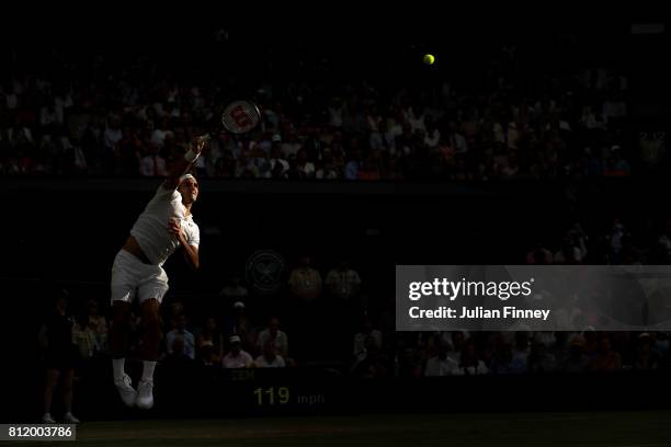 Roger Federer of Switzerland serves during the Gentlemen's Singles fourth round match against Grigor Dimitrov of Bulgaria on day seven of the...