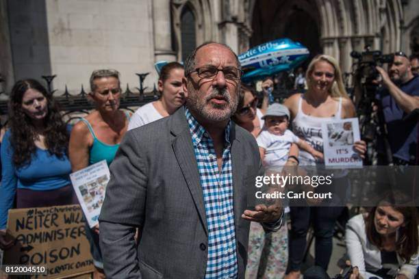 Supporters of Chris Gard and Connie Yates, the parents of terminally ill toddler Charlie Gard, look on as Reverend Patrick Mahoney speaks to the...