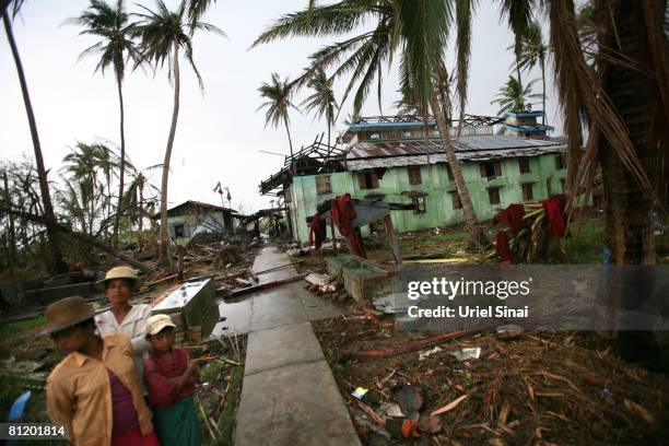 Locals near a damaged monastery May 20 at the isolated village of Mingala Taungtan in the Ayeyarwaddy delta, Myanmar. It has been estimated that more...