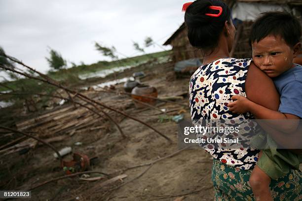 Woman holds her boy May 20 at the isolated village of Myasein Kan in the Ayeyarwaddy delta, Myanmar. It has been estimated that more than 100,000...