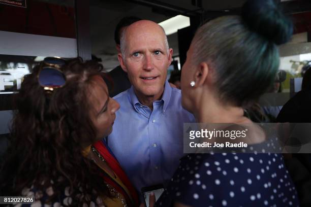 Florida Governor Rick Scott interacts with people as he holds a Venezuelan Freedom Rally at El Arepazo 2 restaurant on July 10, 2017 in Miami,...