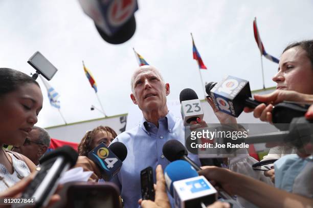 Florida Governor Rick Scott speaks to the media as he holds a Venezuelan Freedom Rally at El Arepazo 2 restaurant on July 10, 2017 in Miami, Florida....