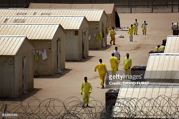 Iraqi detainees walk inside the Camp Bucca detention centre located near the Kuwait-Iraq border, on May 20, 2008. There are approximately 22,000...