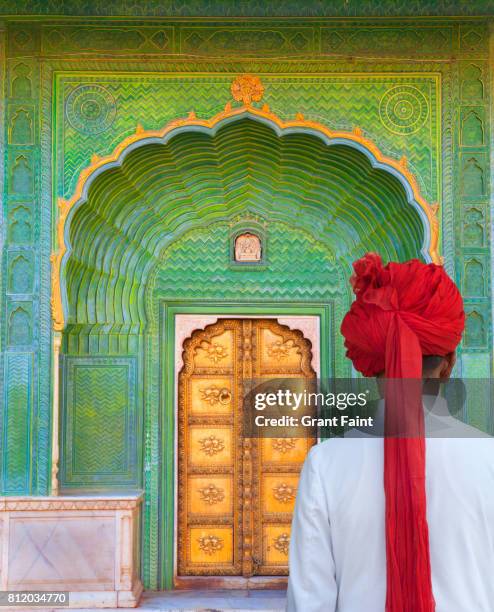 tour guide near doorway. - jaipur city palace stock pictures, royalty-free photos & images